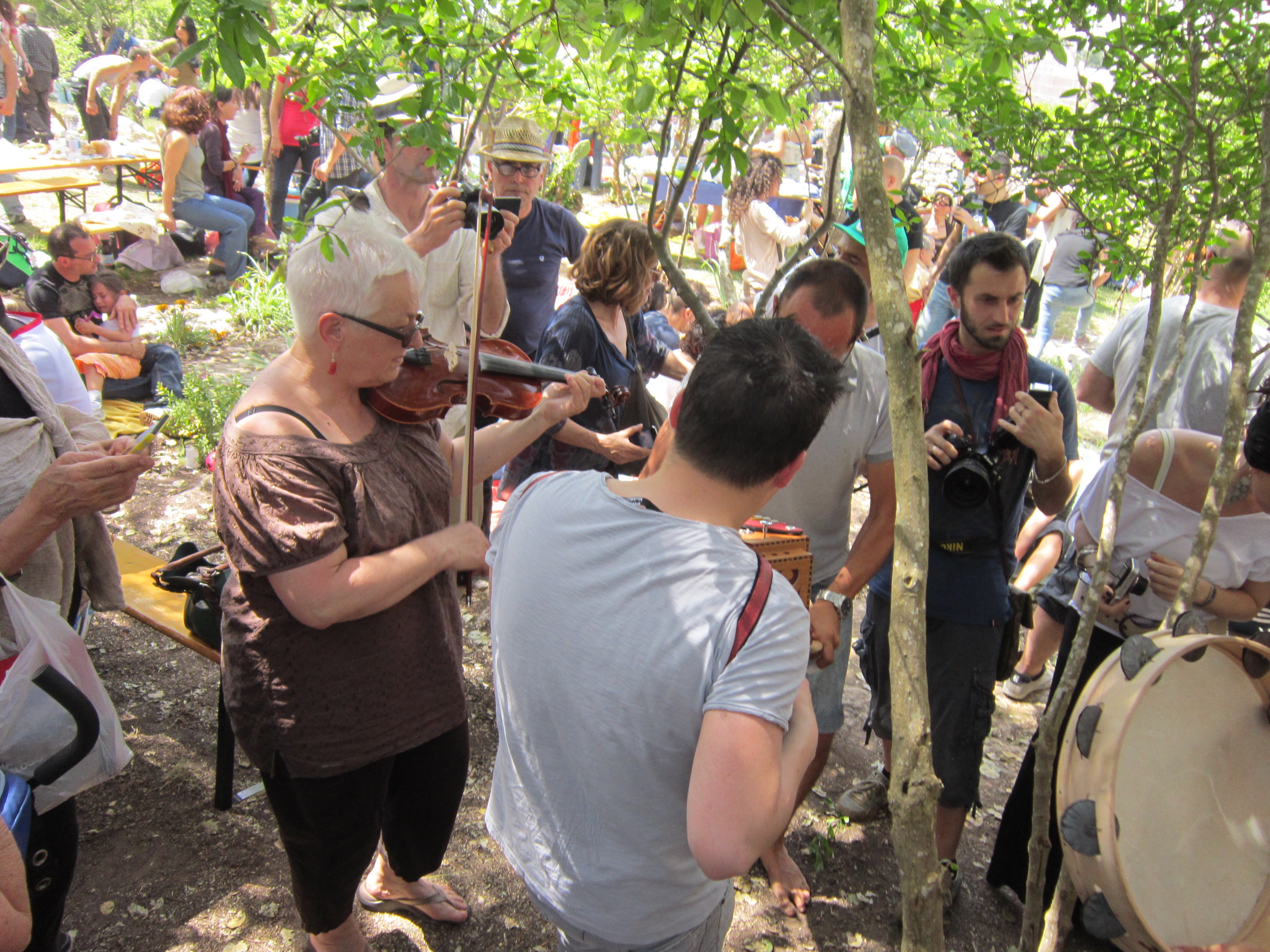 People playing, and dancing to, typical Puglia folk music named 'pizzica'