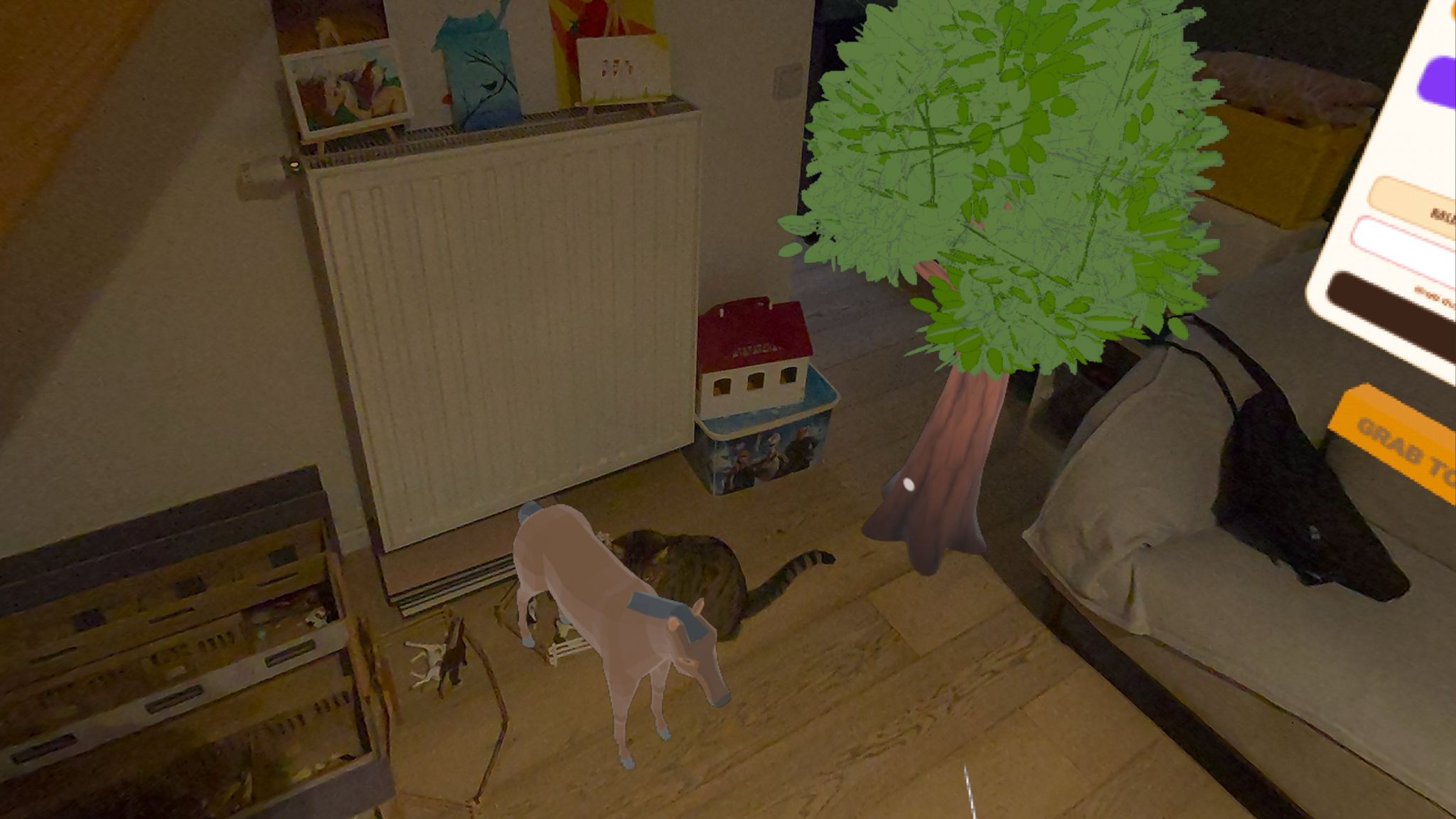 Mixed-reality view of a room corner with a virtual low-poly foal and green tree blended into the real floor beside a radiator, a toy house and a real cat, with a 'Grab to move' control visible